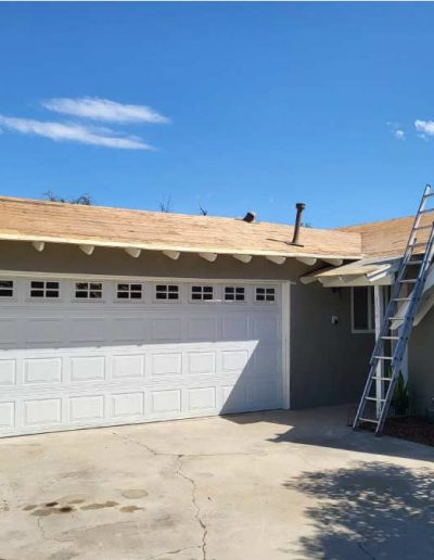 Roofing team installing new asphalt shingles on a residential home, ensuring precision and durability