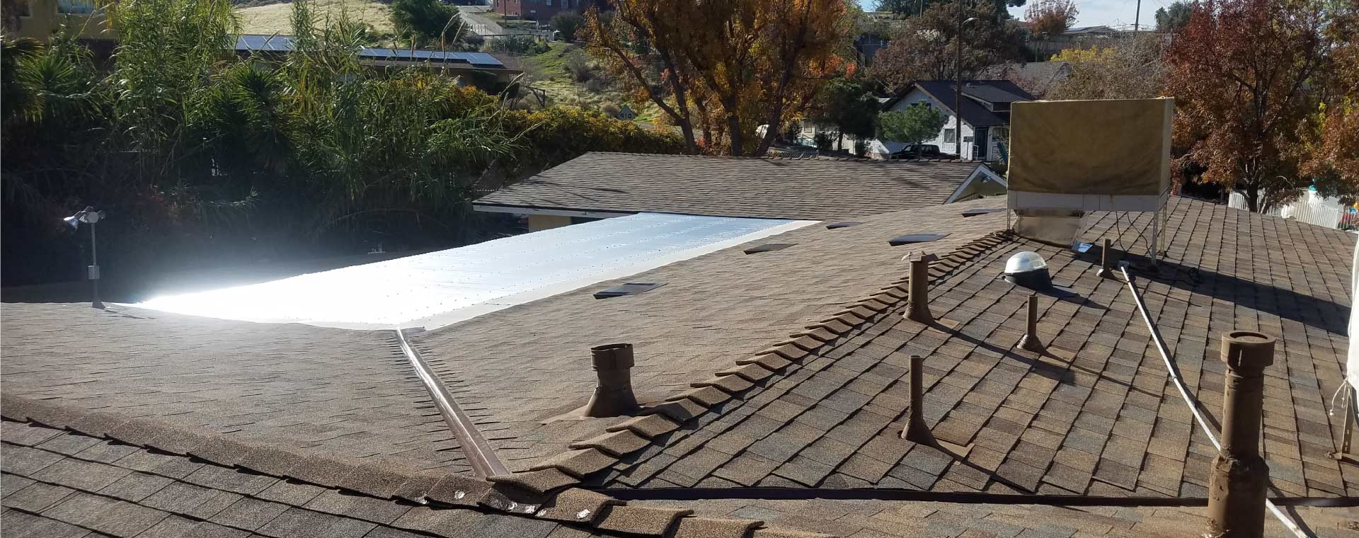 A close-up view of high-quality architectural asphalt shingles, a key factor in a new roof's cost.