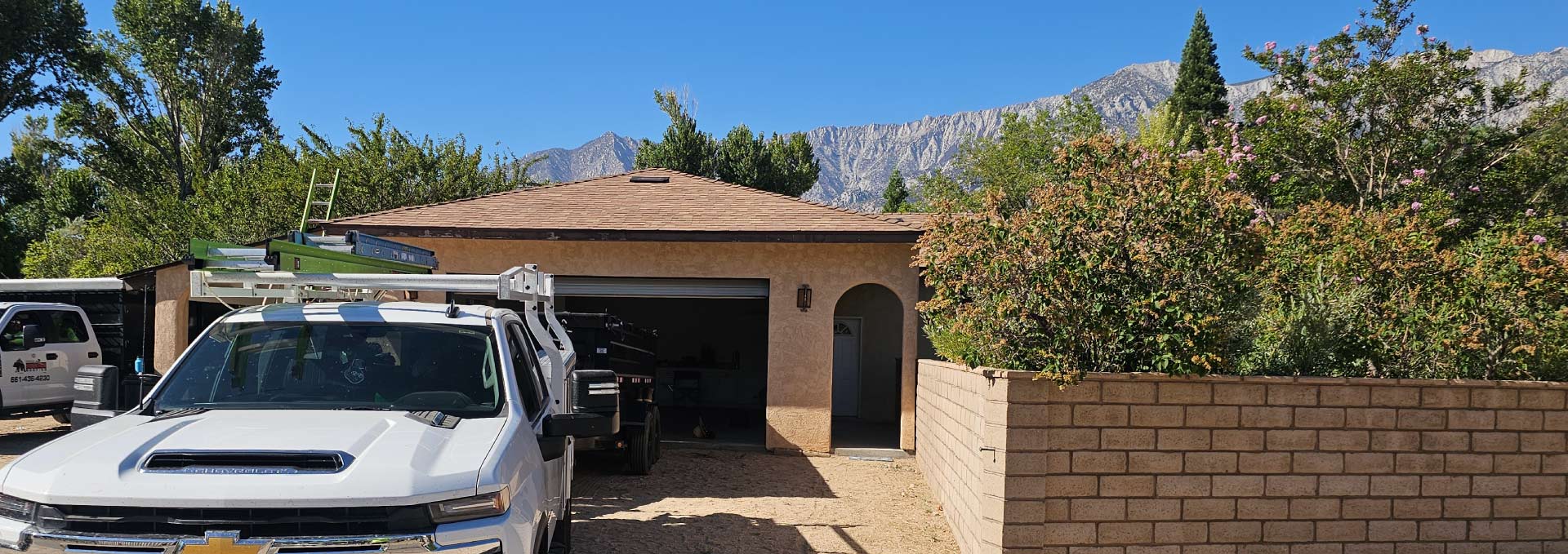 A Bear Mountain Roofing expert carefully measuring a roof to provide an accurate installation estimate.