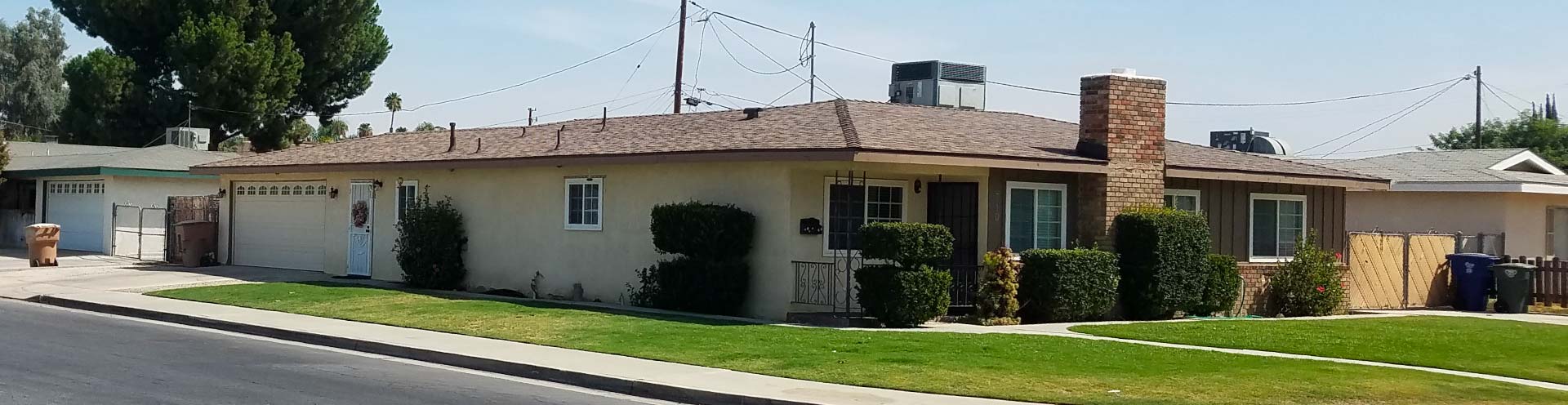 A completed residential asphalt shingle roof installation on a single-story home in Sacramento, featuring clean ridge lines, new chimney flashing, and professional ventilation for long-term durability.